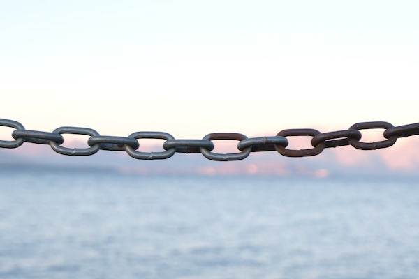 metal chain in front of ocean
